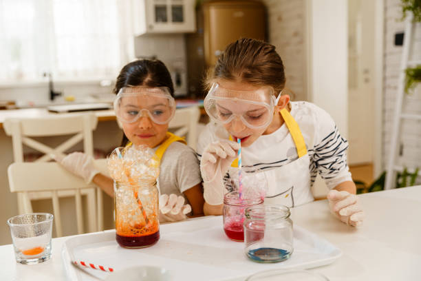 istock Two girls having fun making experiments at home 1950615804