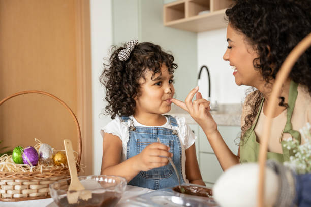 istock Mother and daughter making chocolate eggs for Easter 1950625852