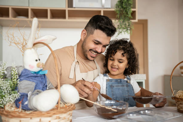 istock Father and daughter making chocolate eggs 1950626377