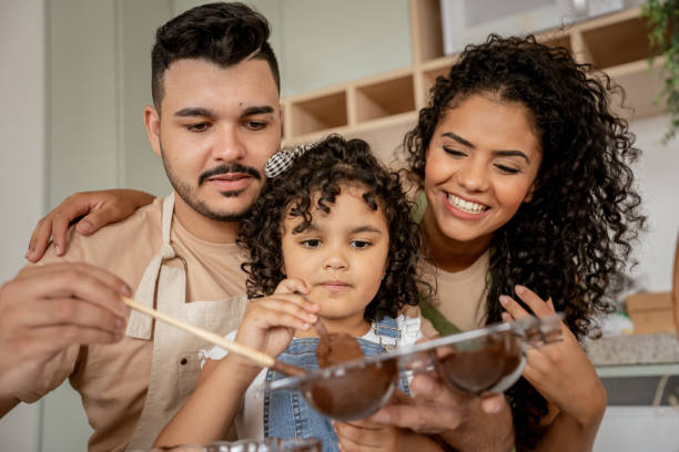 istock Family with a daughter making chocolate for Easter 1950627437