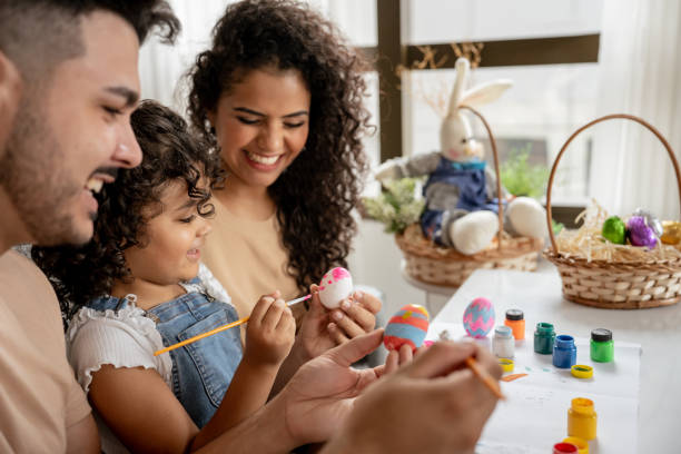 istock Family with daughter painting Easter eggs 1950628474