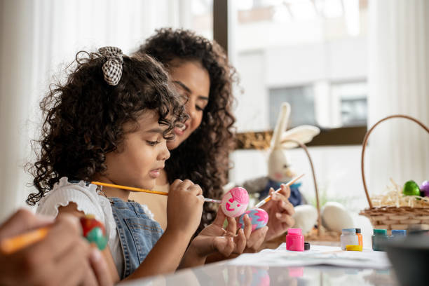 istock Family with daughter painting Easter eggs 1950630045