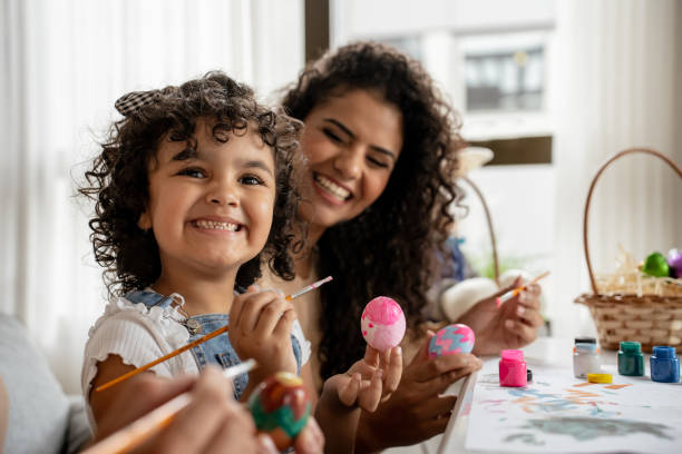 Portrait of child painting Easter eggs