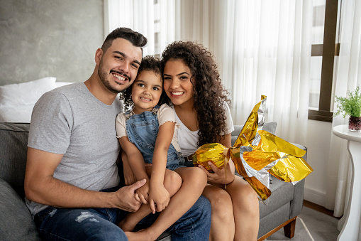 Portrait of happy family holding easter egg