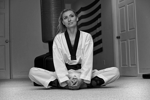 Martial artist sitting contemplating.