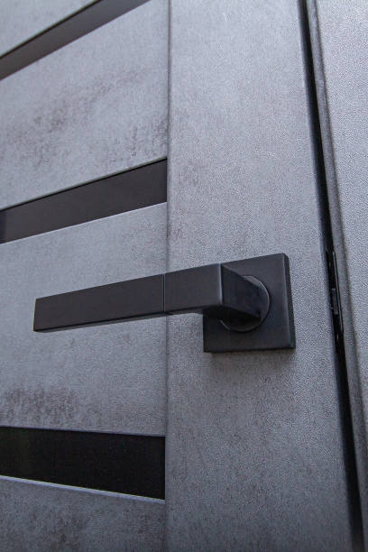 istock black handle on a gray ajar door close-up 1950641006