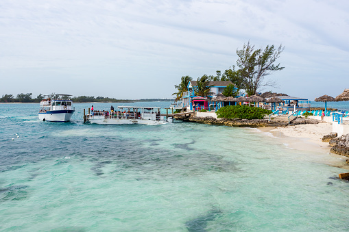 Pearl Island, Bahamas - January 9th, 2024: Boat with a group of tourists moored to the shore