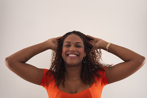 Portrait of young woman running hands through her hair