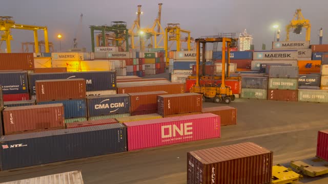 Global Trade Hub. Night View of Sea Port with Container Cranes and Stacked Shipping Containers