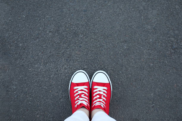 Woman standing on asphalt, top view. Space for text