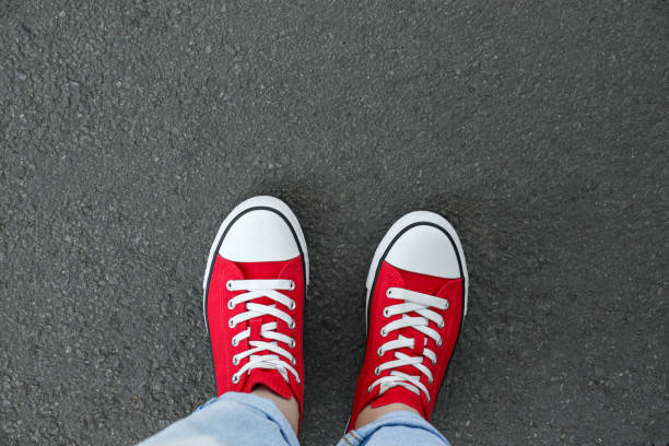 istock Woman standing on asphalt, top view. Space for text 1950695268