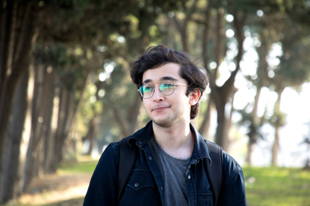 istock Young handsome man in glasses relaxing in nature 1950724841