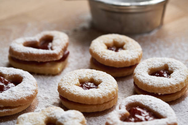 Traditonal Linzer Christmas cookies filled with strawberry marmalade and dusted with sugar