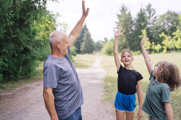 istock Kids and their coach are doing workout trainings in the park. 1950738812