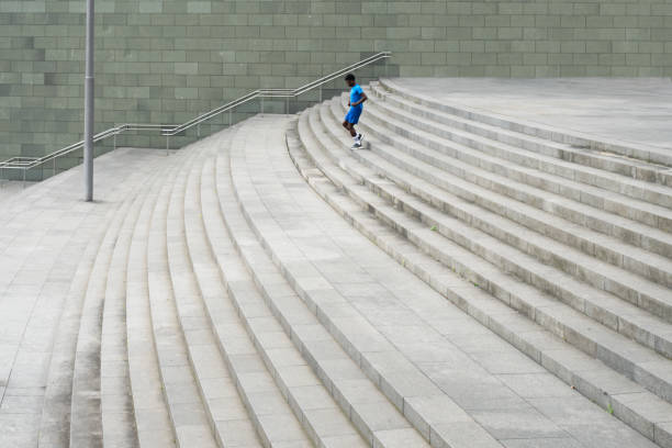 istock Graceful Descent: Young Man in Blue Sportswear Mastering the Stairs 1950752910