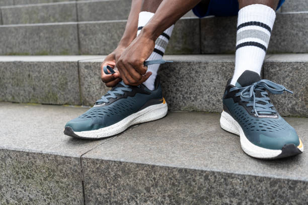 istock Focused Preparation: Tying Shoelaces on Urban Stairs 1950753184