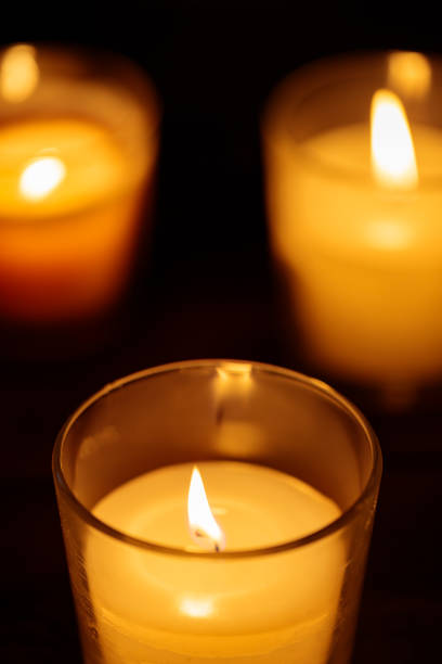 istock Burning Aromatic Candles in Glass on Dark Background, Close-up 1950759212