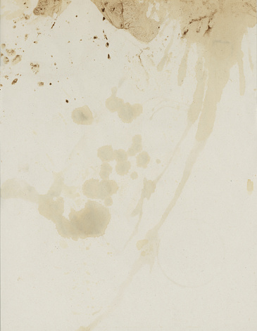 Close up of antique paper texture with coffee stains.