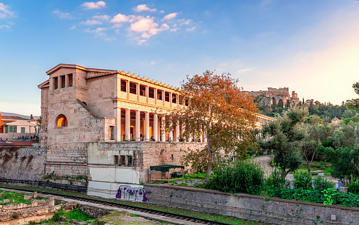 Athens, Greece - December 29 2023: The Stoa of Attalos and the Ancient Agora, with the Acropolis on top of the Acropolis Hill in the background.