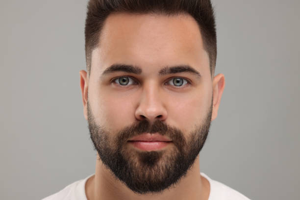 istock Portrait of young man on light grey background, closeup 1950841529