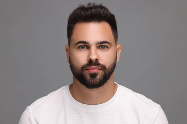 istock Portrait of young man on light grey background 1950843789