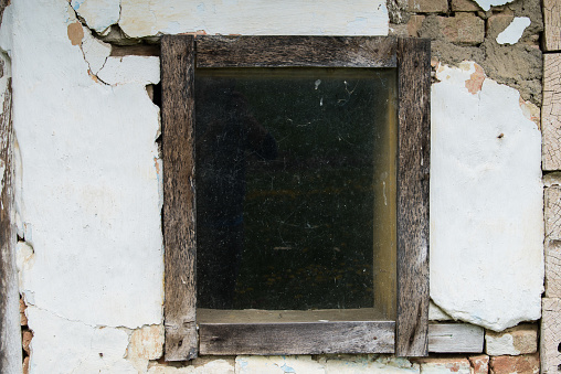 Croatia, October 20,2023 : Rustic style aged window at rural home wall.