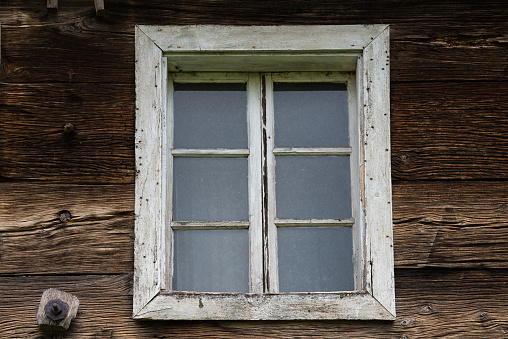 Window in the wattle and daub wall with shutters