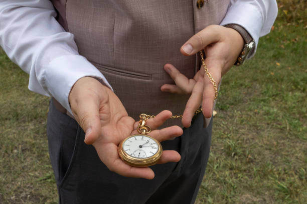 istock Human hands holding a gold colored old fashioned time piece 1950902018