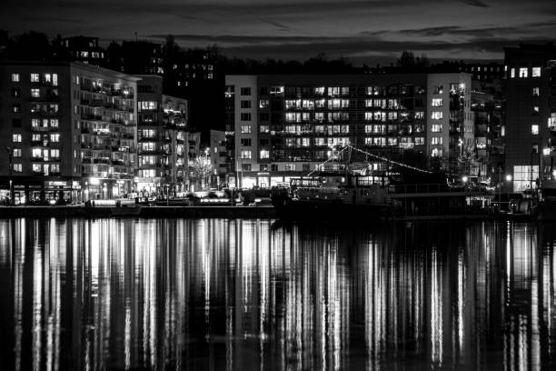 istock View of river by buildings against sky at night 1950907909