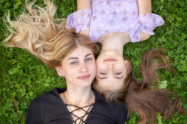 istock Mother and daughter embracing on grass 1950926655
