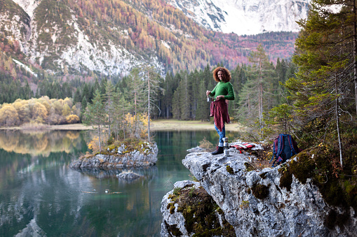 Adult Woman Hiker Eating a Warm Meal on a beautiful Spot in Mountains Environment