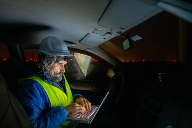 istock Night shift at wind farm. Engineer works late in car. 1951089442