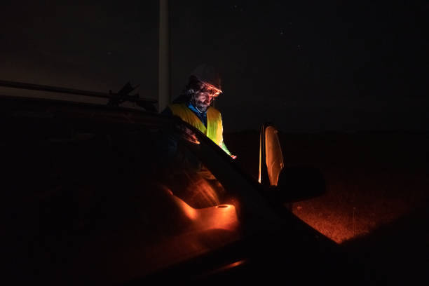 istock Night shift at wind farm. Engineer works late in car. 1951089455