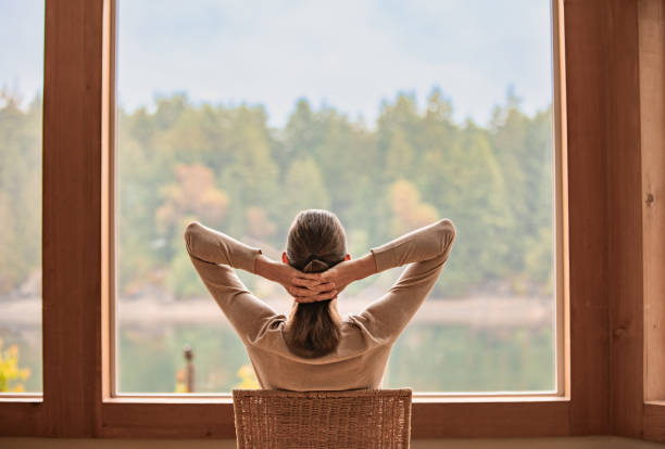istock Woman relaxing and enjoying beautiful view from the window. 1951132364