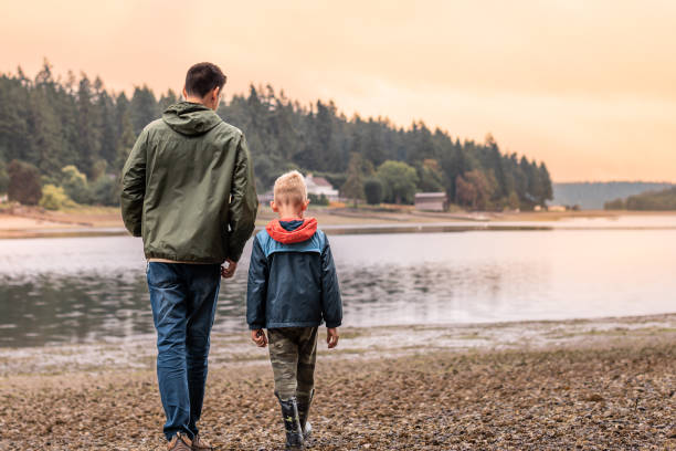 istock Father and son walking together at sunset. 1951163400