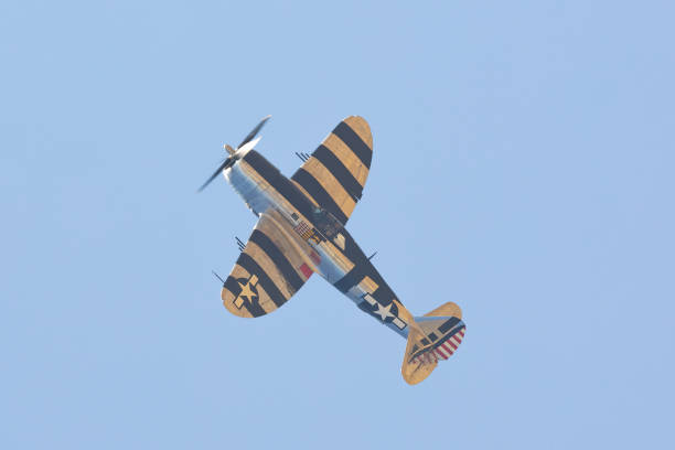 istock P-47G Thunderbolt (WWII American fighter plane) with  its “Invasion Stripes”, in a climb 1951170958