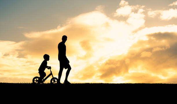 istock Father teaching his son ride a bike. 1951177182