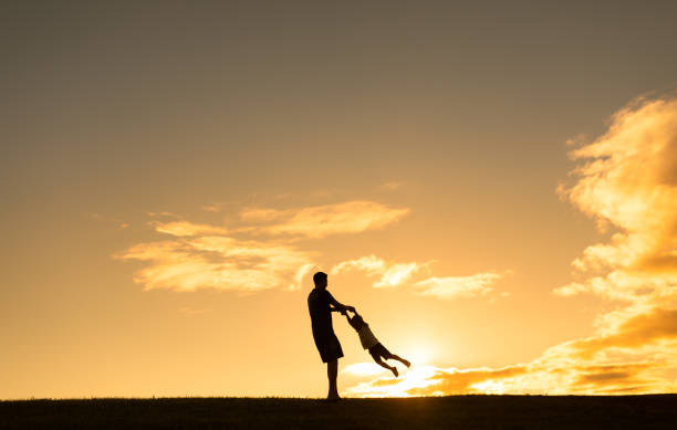 istock Father playing with his son outdoors at sunset. 1951178214