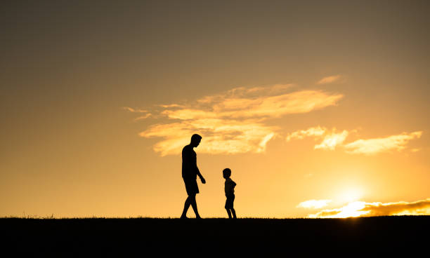istock Father and son in the park at sunset. 1951178382