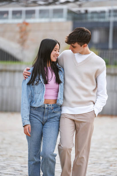 istock Affectionate couple embracing and walking in the city. 1951183495