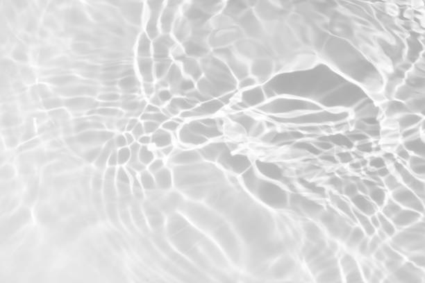 istock White water with ripples on the surface. Defocus blurred transparent white colored clear calm water surface texture with splashes and bubbles. Water waves with shining pattern texture background. 1951200562