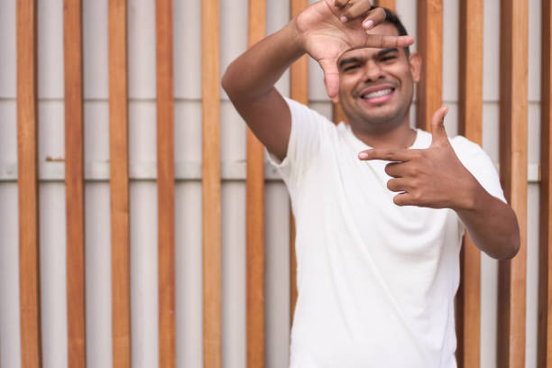 istock Latin man with braces gesturing frame with fingers 1951284282