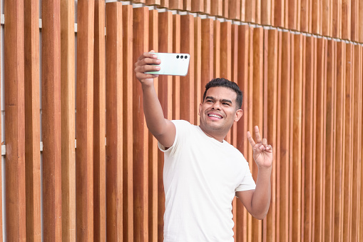 Latin Man Taking a Selfie with Braces
