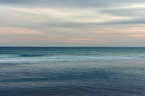 Ocean and cloudy sky, abstract background, motion blur.