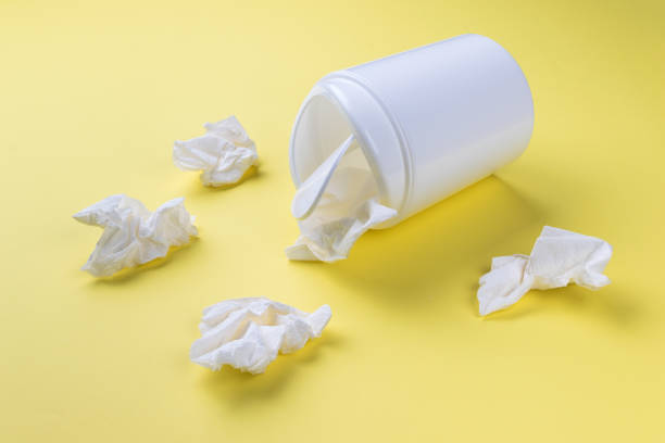 istock An overturned trash can and crumpled paper on a yellow background. 1951333745
