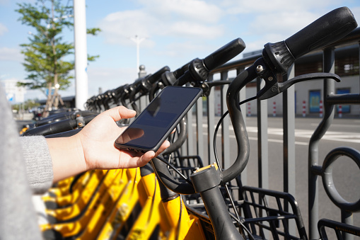 Woman is paying for shared bike