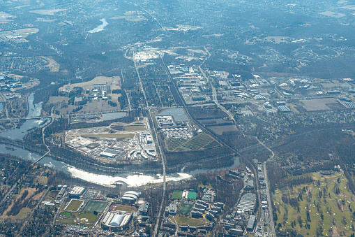 Aerial view of Princeton, New Jersey featuring the Princeton Campus, Princeton Stadium, Carnegie Lake, a pedestrian bridge and new construction on campus