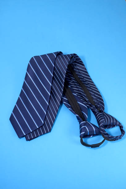 istock Pairing neckties together isolated on blue background close-up view 1951440526