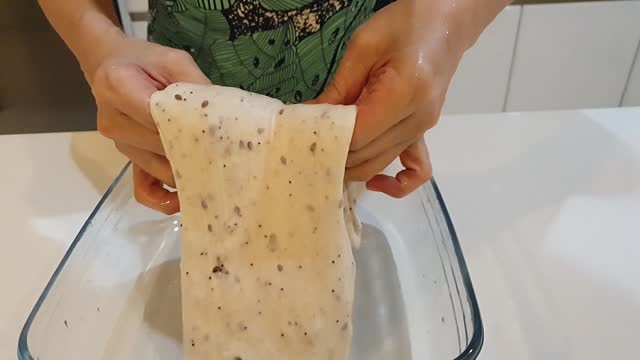 Footage of female hand preparing sourdough flour starter, homemade, kneading, artisan, home cooking, making bread, traditional recipe, how to make sourdough, fresh food