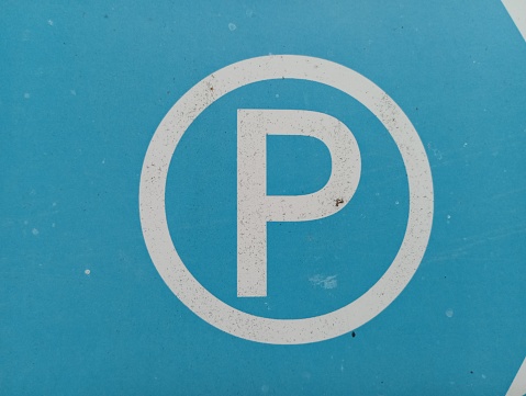 The Latin letter n is circled on a blue background. Parking road sign.